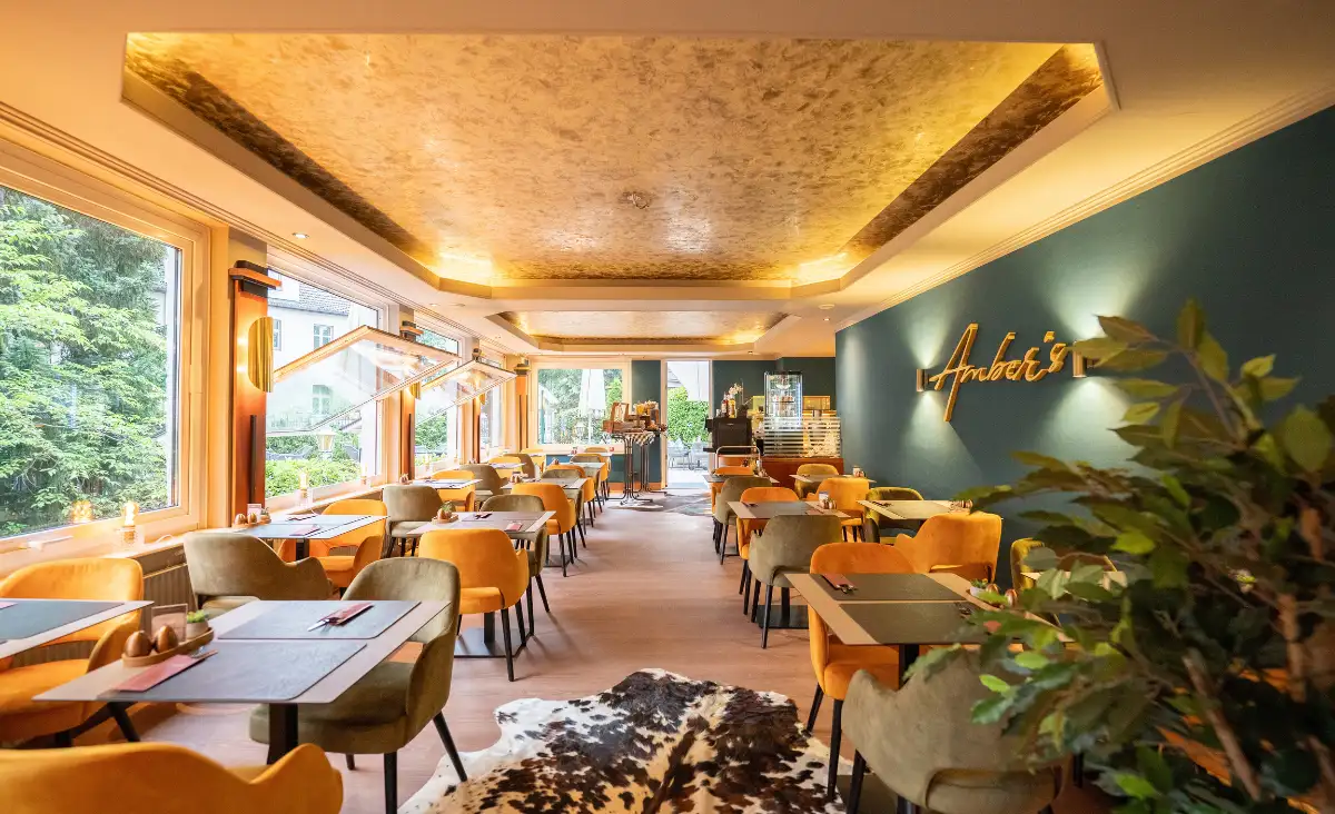 Ein Restaurant mit gelben und blauen Wänden, dekoriert mit einem Kuhfellteppich für eine gemütliche Atmosphäre.