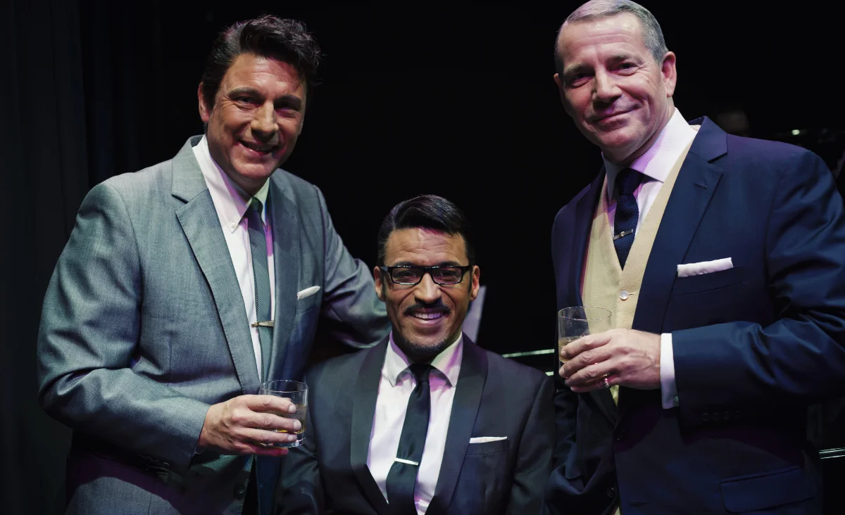 Drei elegant gekleidete Männer stehen für ein Foto während der Show "Sinatra & Friends"