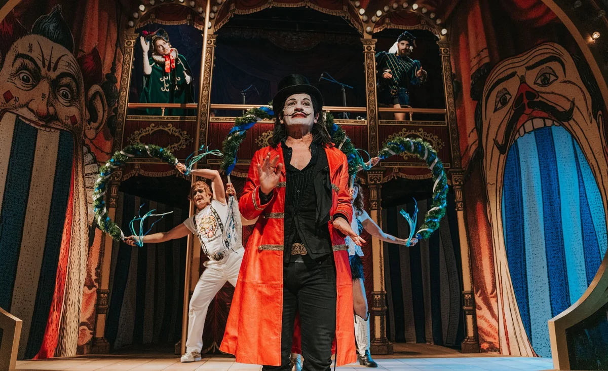 Bunt gekleideter Herr trägt etwas auf einer Bühne vor im Renaissance Theater Berlin 2025