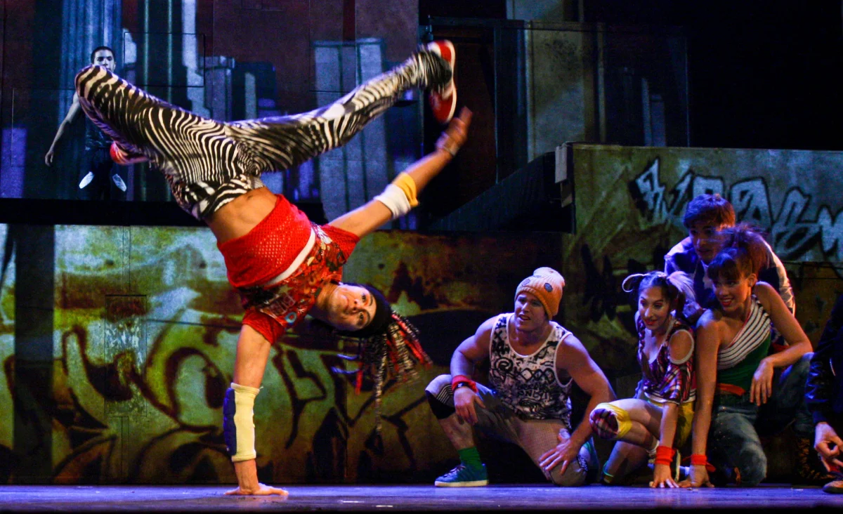Ein Mann macht einen Handstand auf einer Bühne während einer Aufführung von Cirque Éloize.